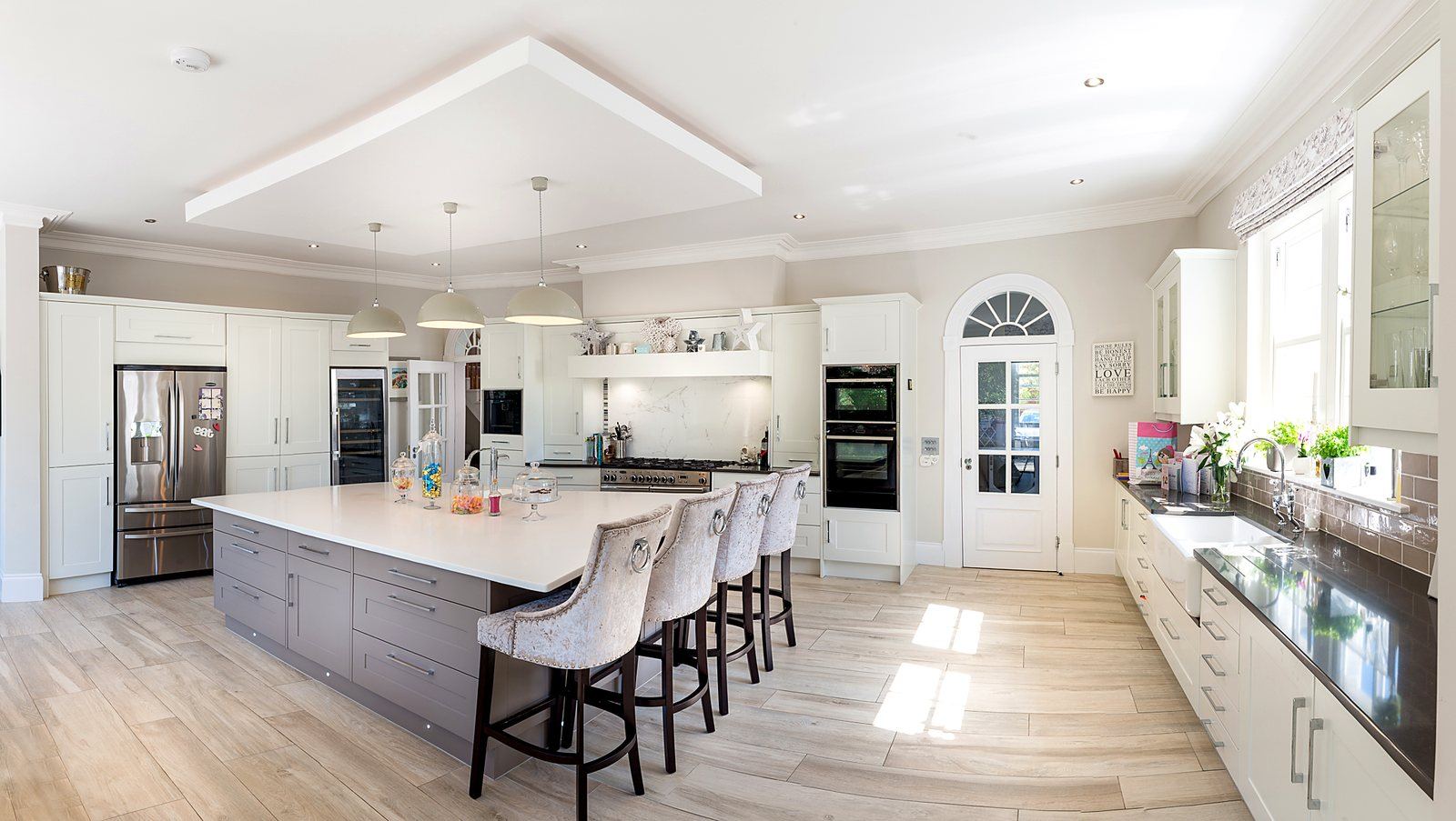 Renovated kitchen with a large central island and fitted cabinetry